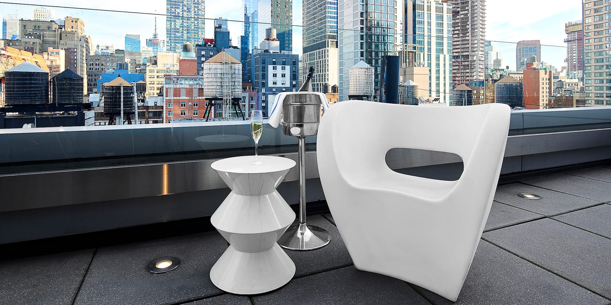 a white chair and a table on a rooftop