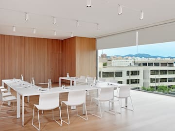 a room with white tables and chairs