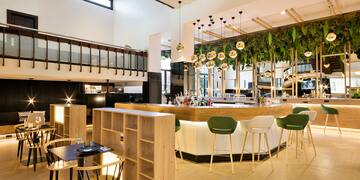 a room with a bar and chairs