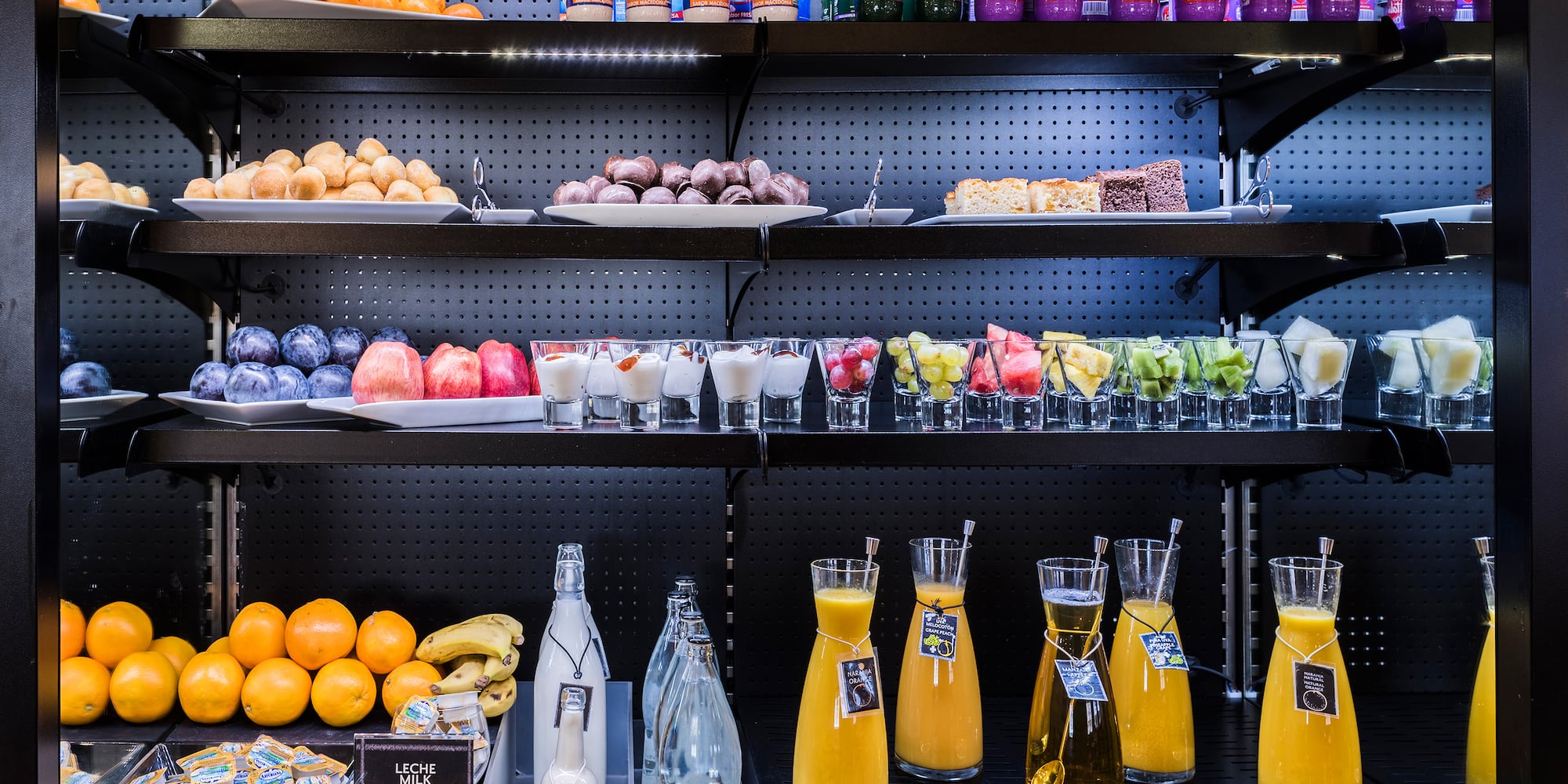 shelves with different drinks and fruits on it