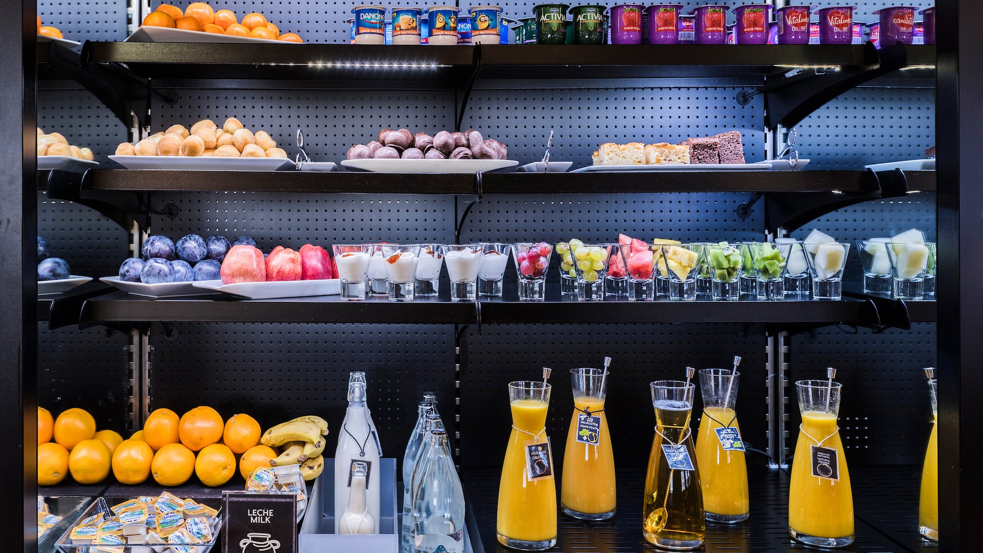 shelves with different drinks and fruits on it