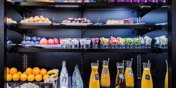 shelves with different drinks and fruits on it