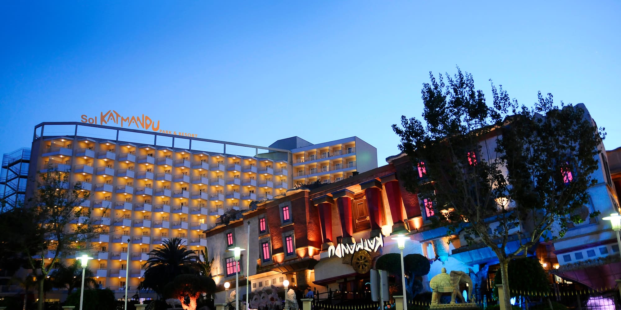 a building with many windows and a statue in front of it