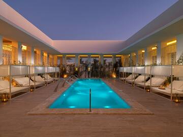 a pool with lounge chairs and a deck