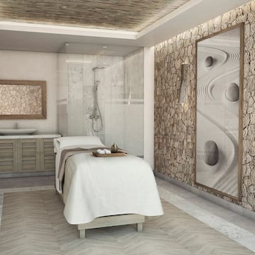 a massage room with a shower and a bed