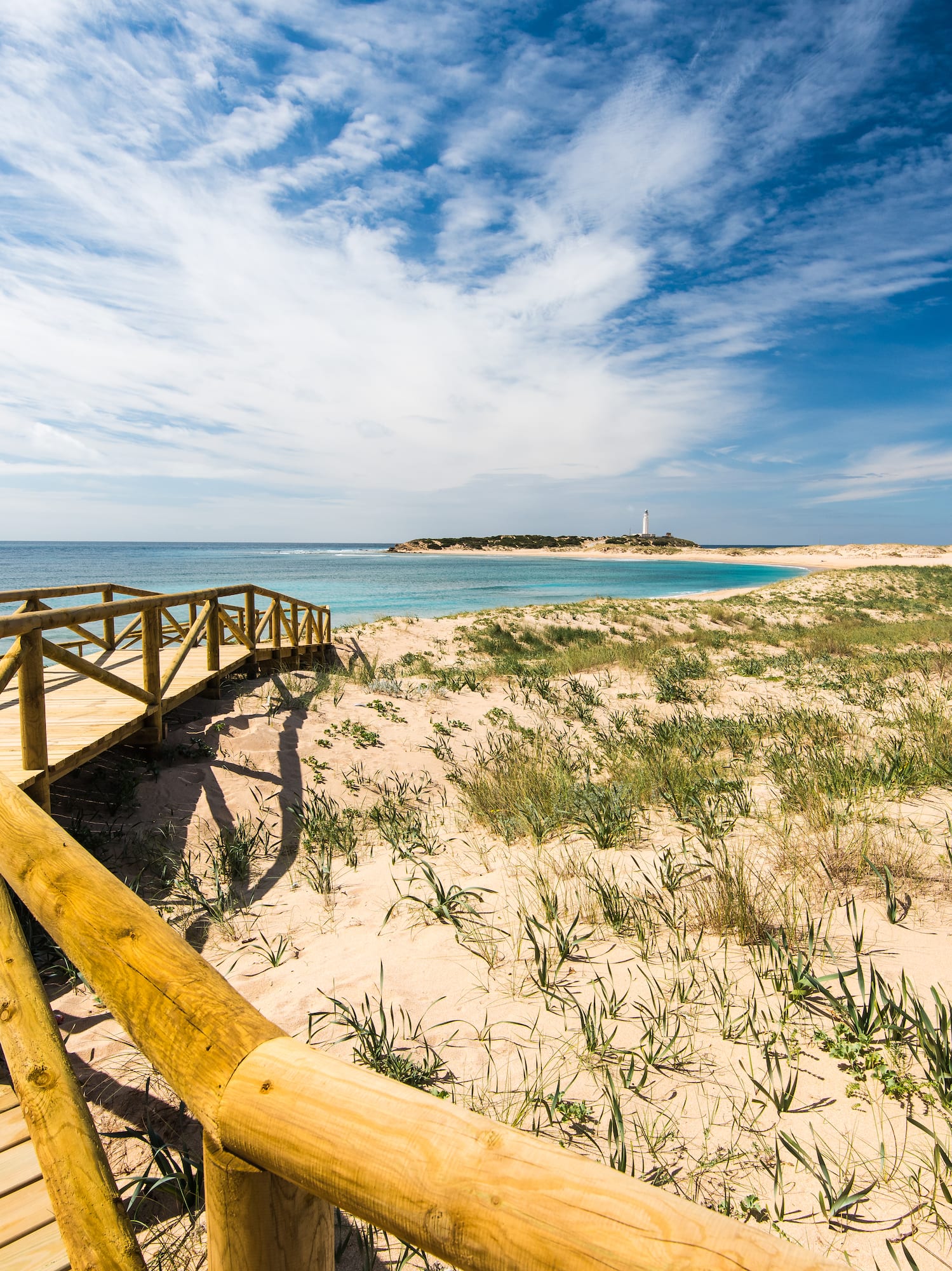 a wooden walkway leading to a beach