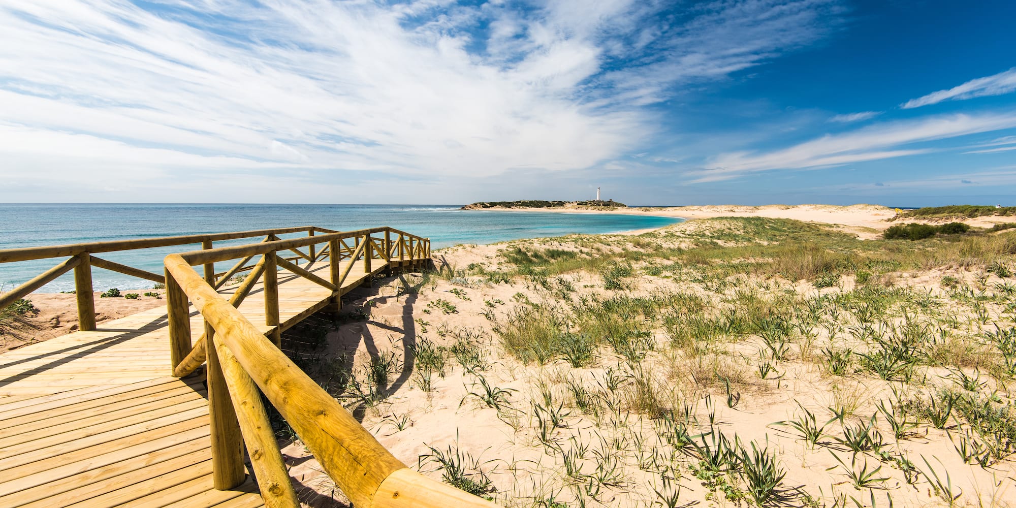 a wooden walkway leading to a beach