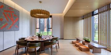 a room with a round table and chairs