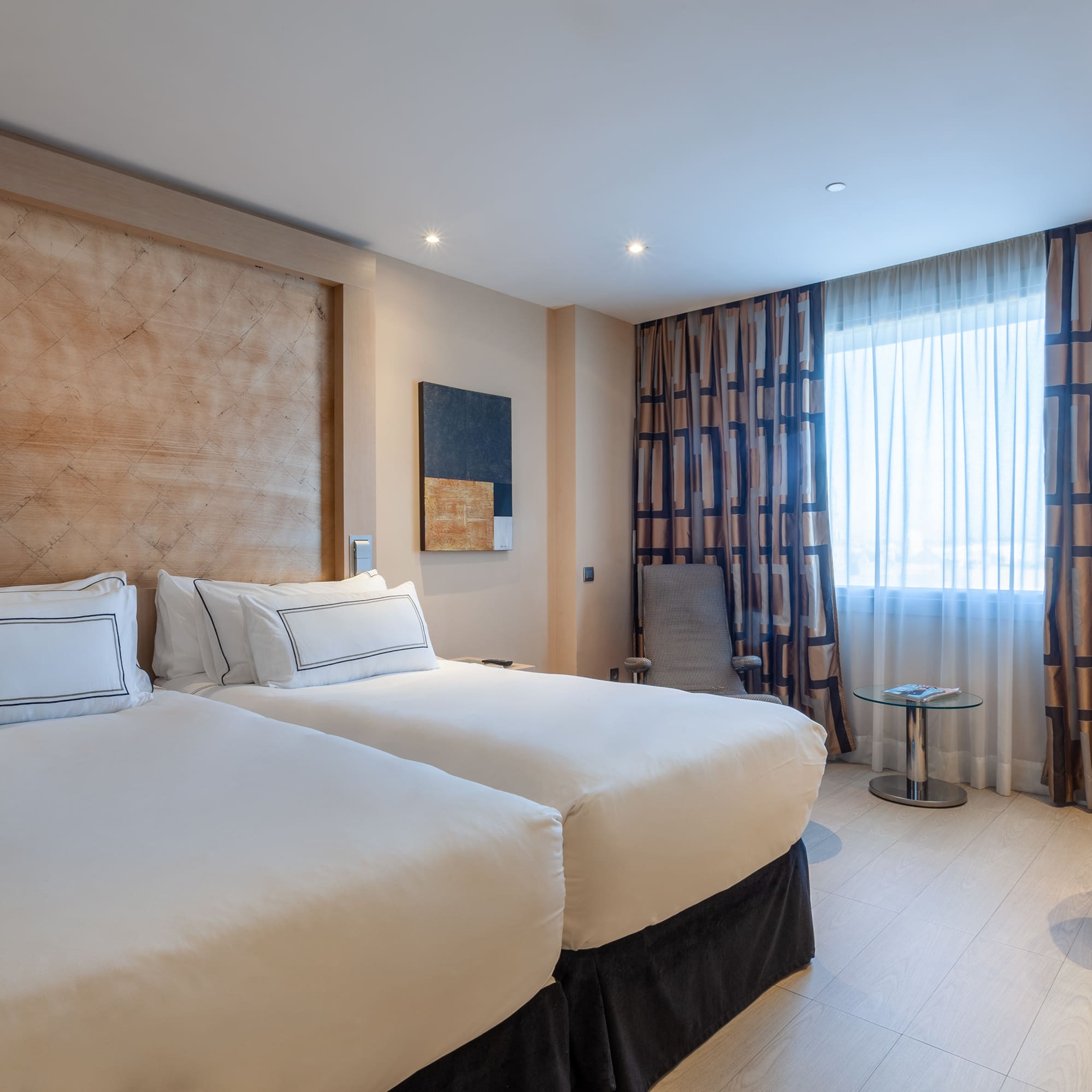 a room with two beds and a table