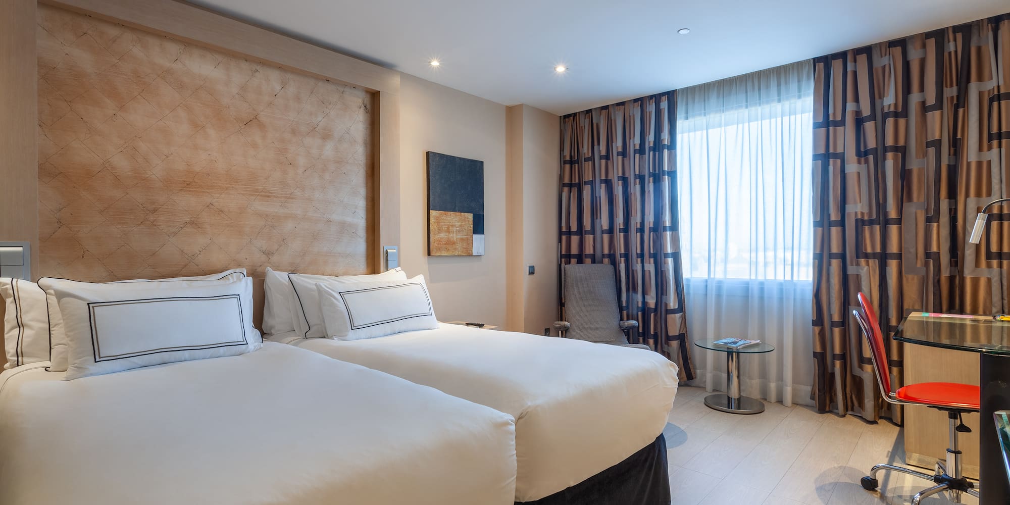 a room with two beds and a table