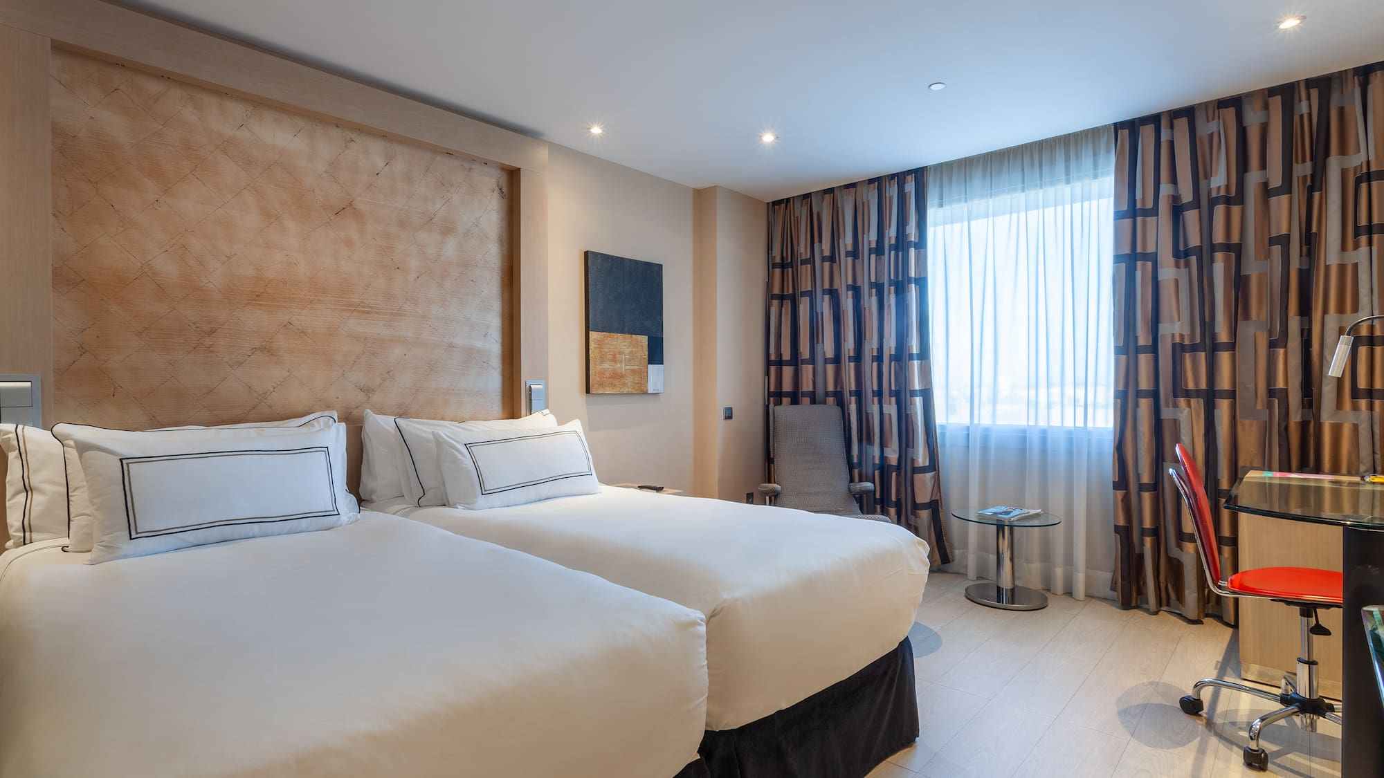 a room with two beds and a table