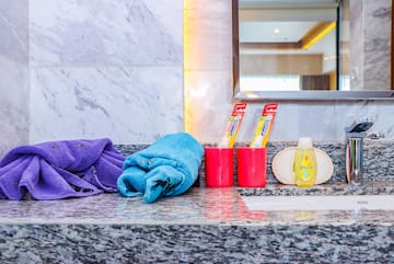 a bathroom sink with towels and toothpaste