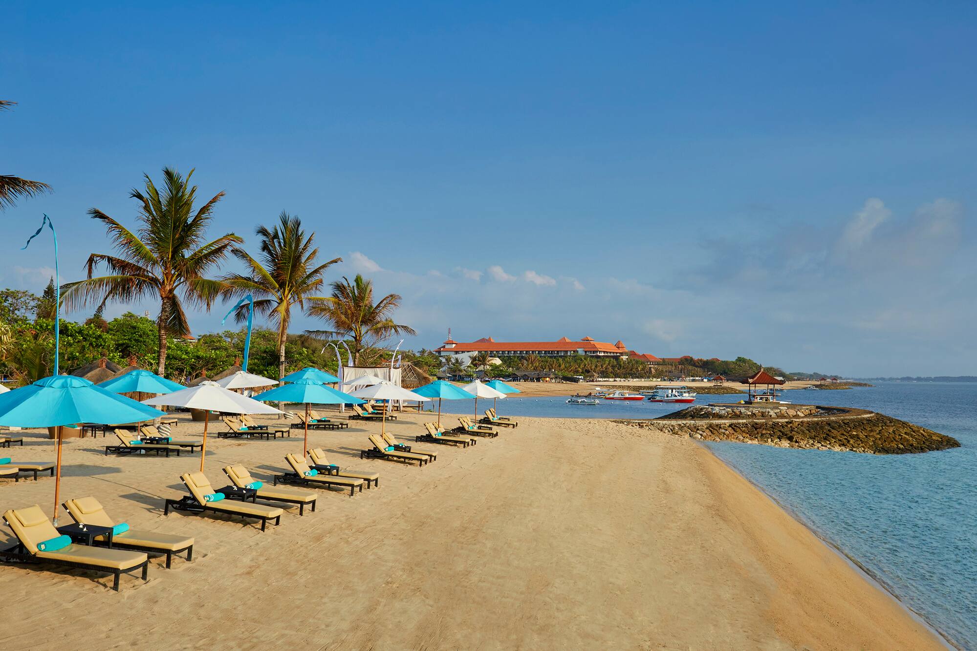 a beach with chairs and umbrellas