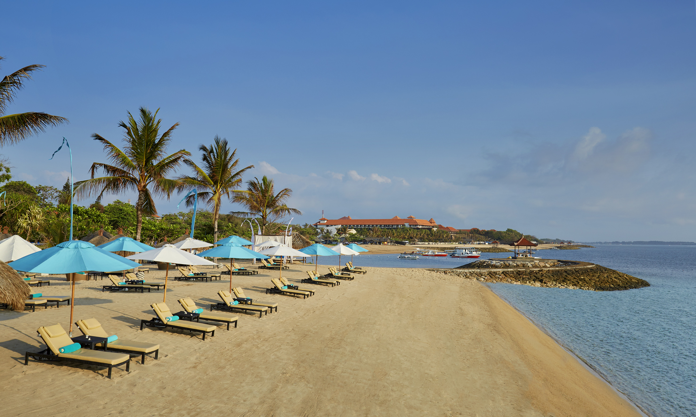 a beach with chairs and umbrellas