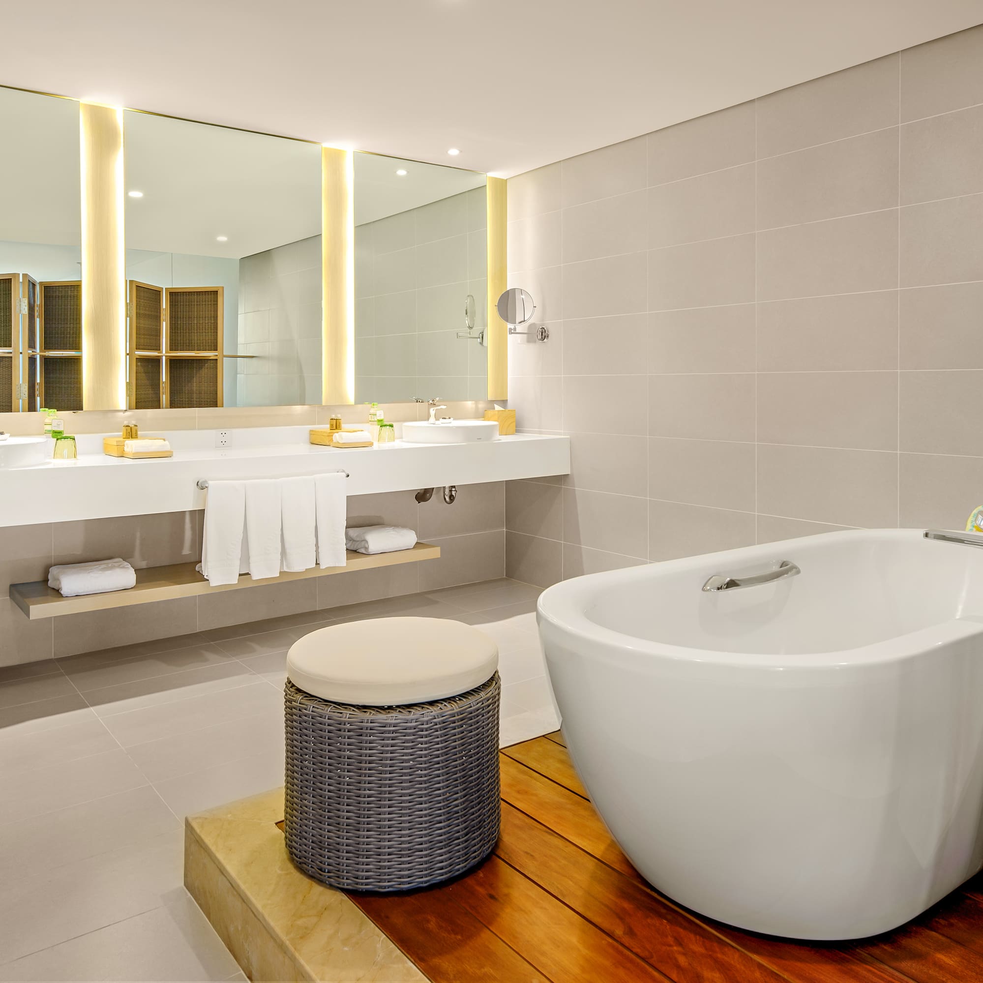 a bathroom with a tub and sinks