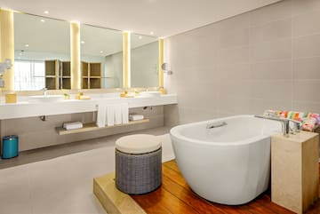 a bathroom with a tub and sinks