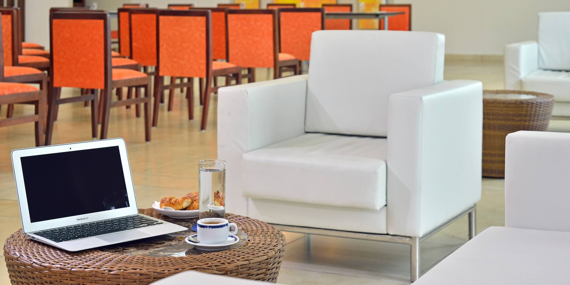 a laptop on a table in front of a chair