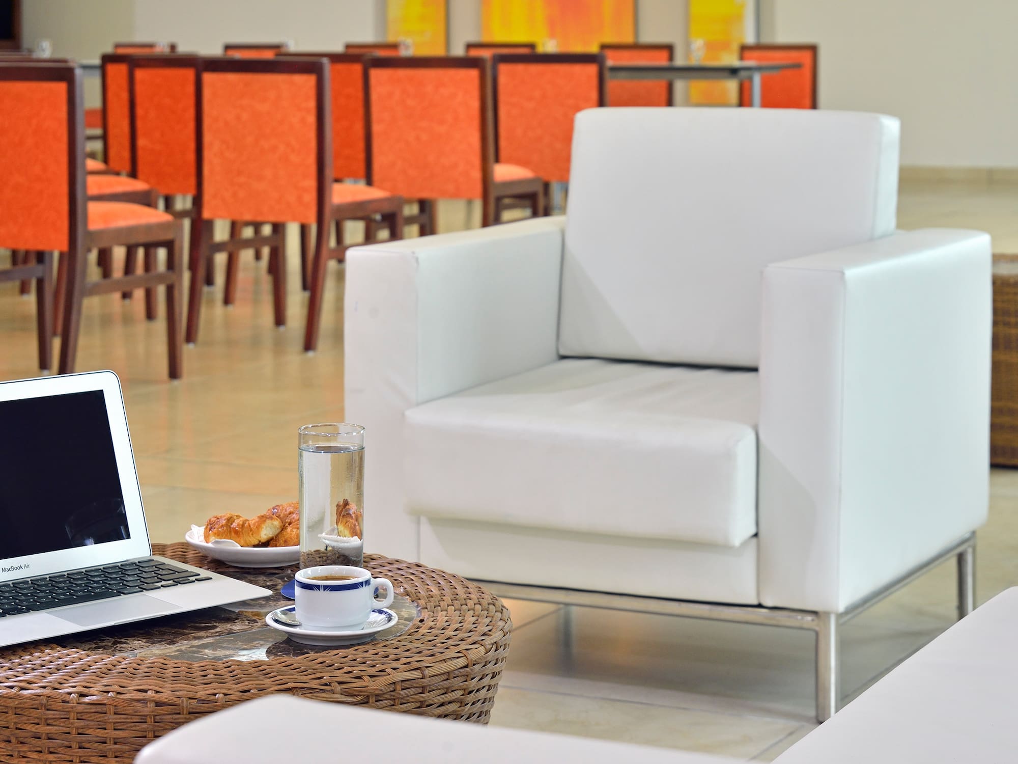 a laptop on a table in front of a chair