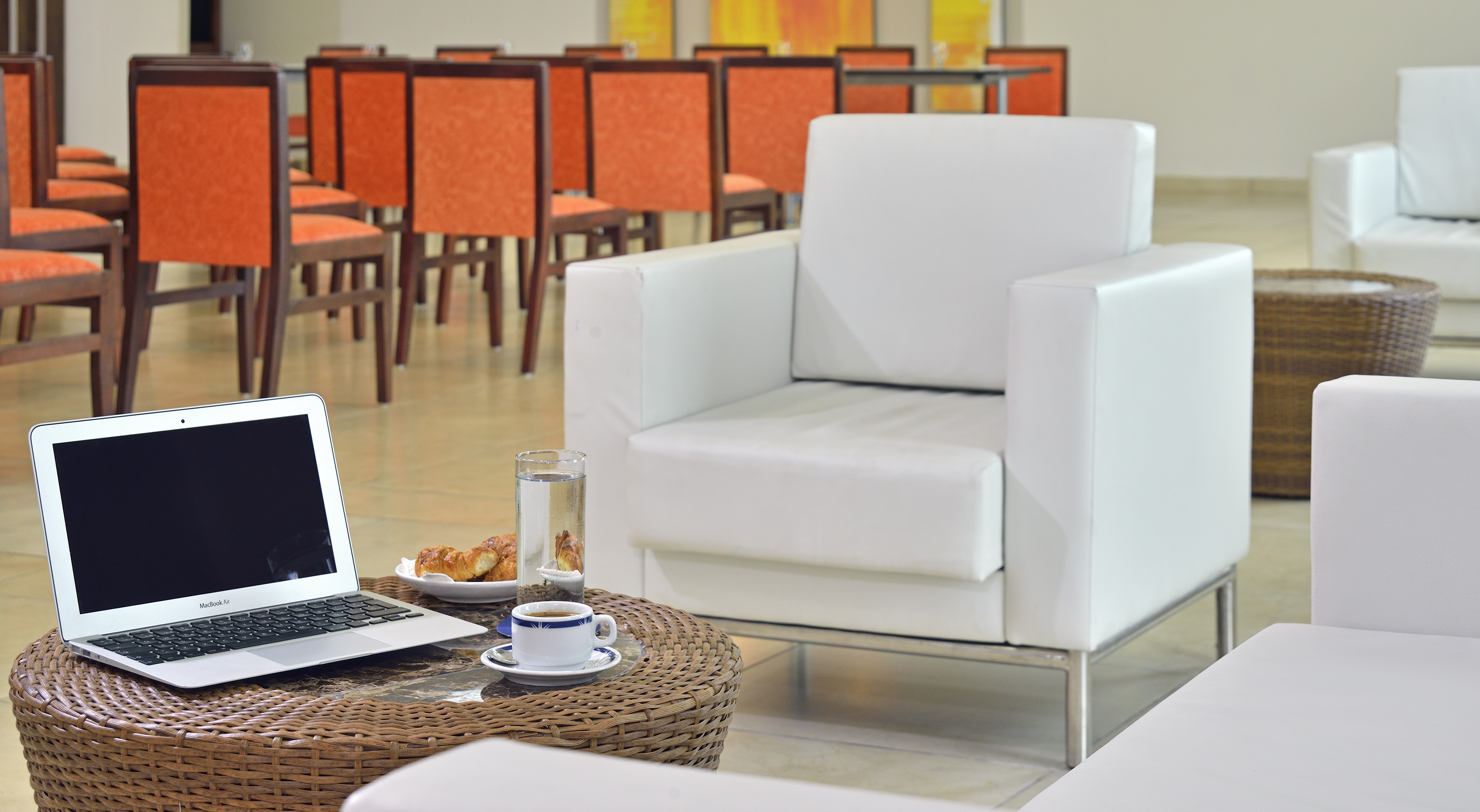 a laptop on a table in front of a chair