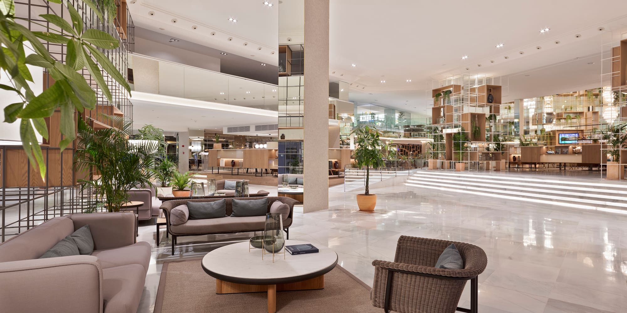 a large lobby with a large staircase and a large room with a large staircase