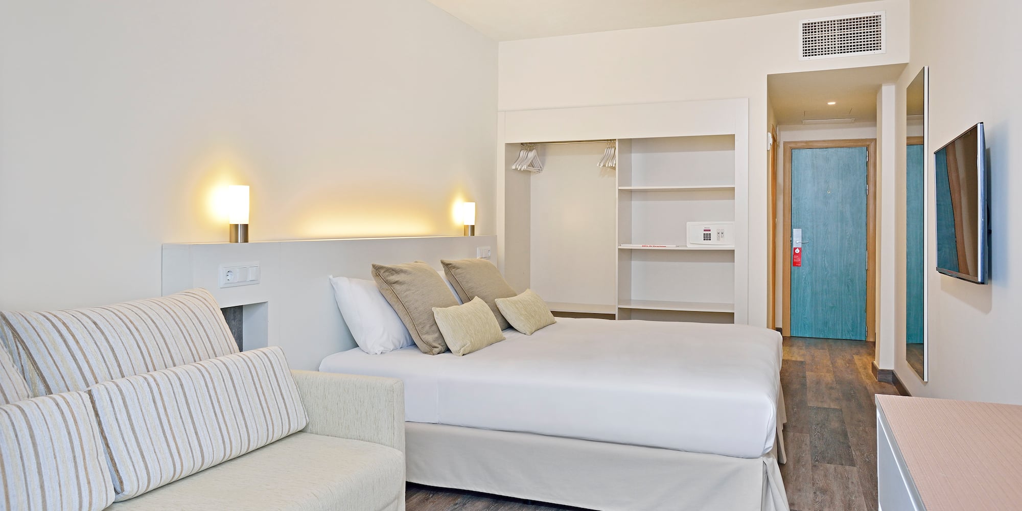 a bedroom with a bed and a couch