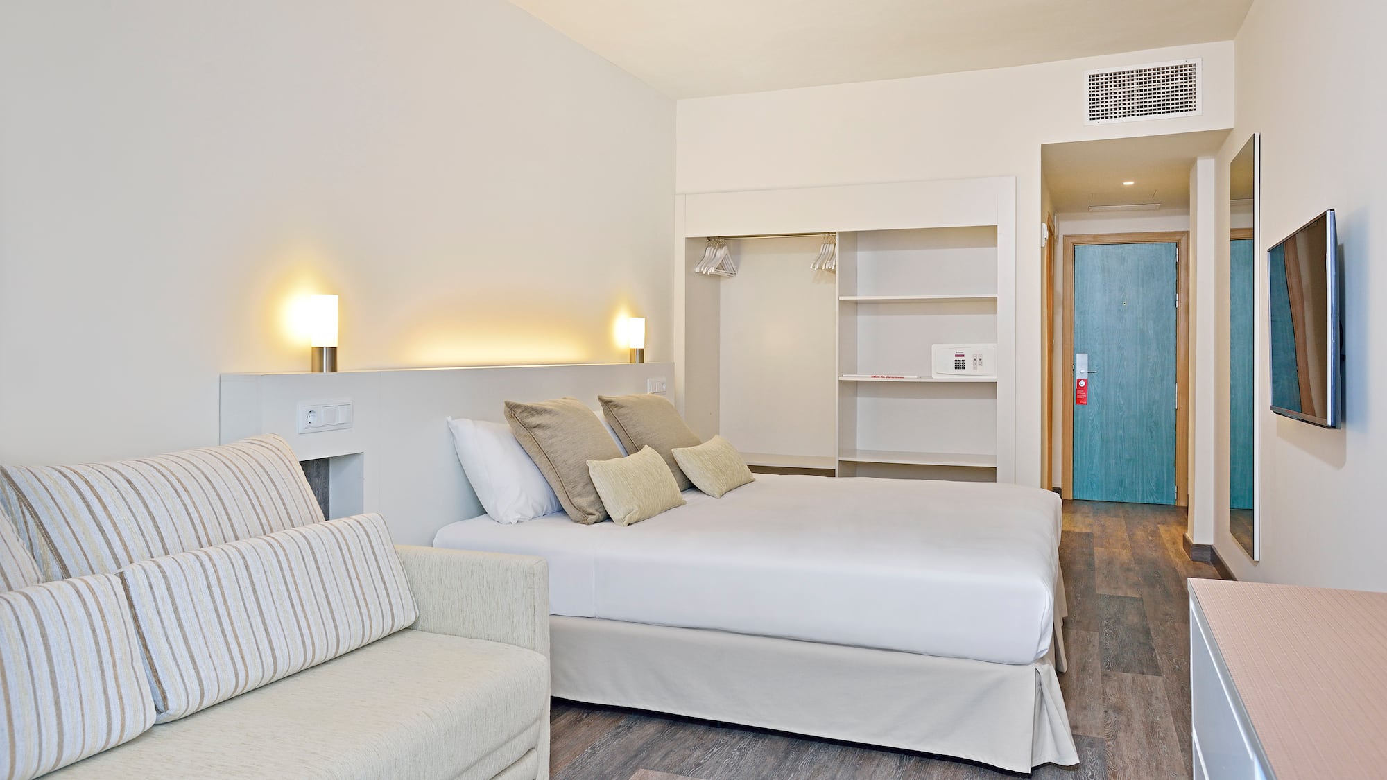 a bedroom with a bed and a couch