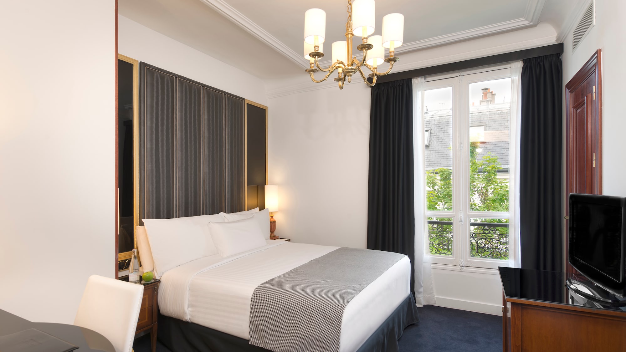 a bedroom with a chandelier and a bed