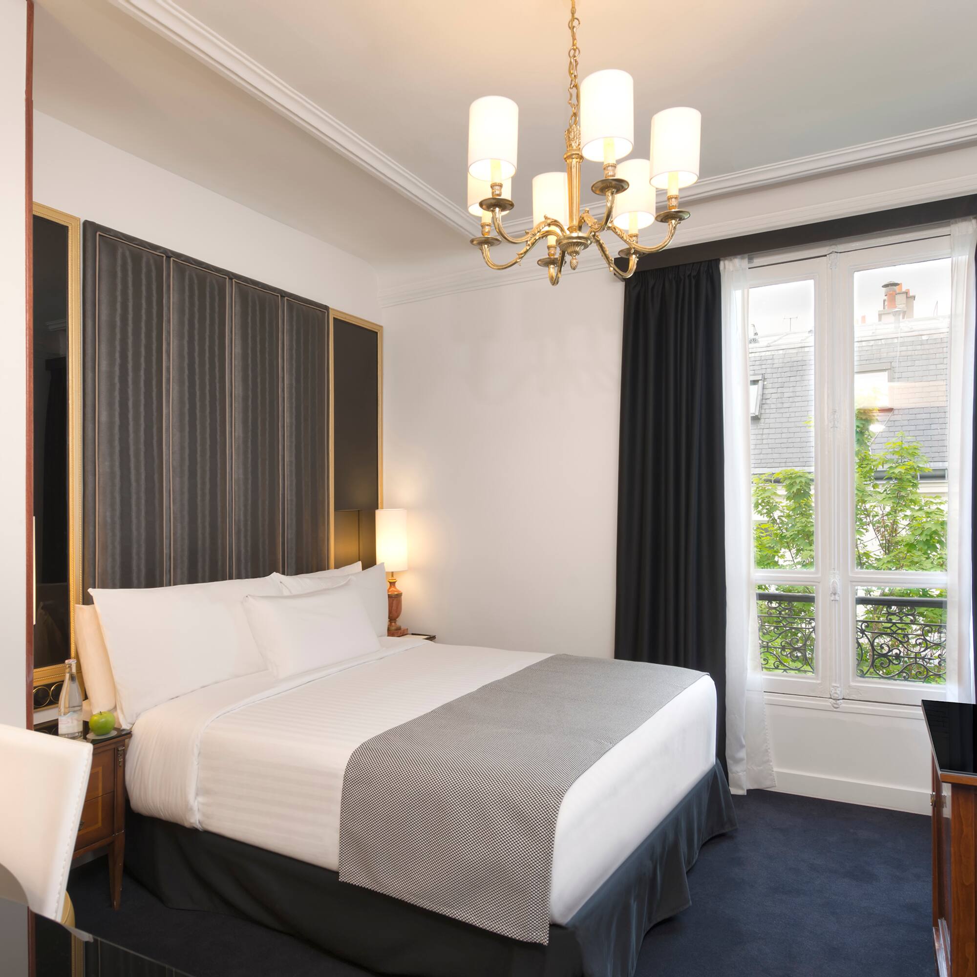 a bedroom with a chandelier and a bed