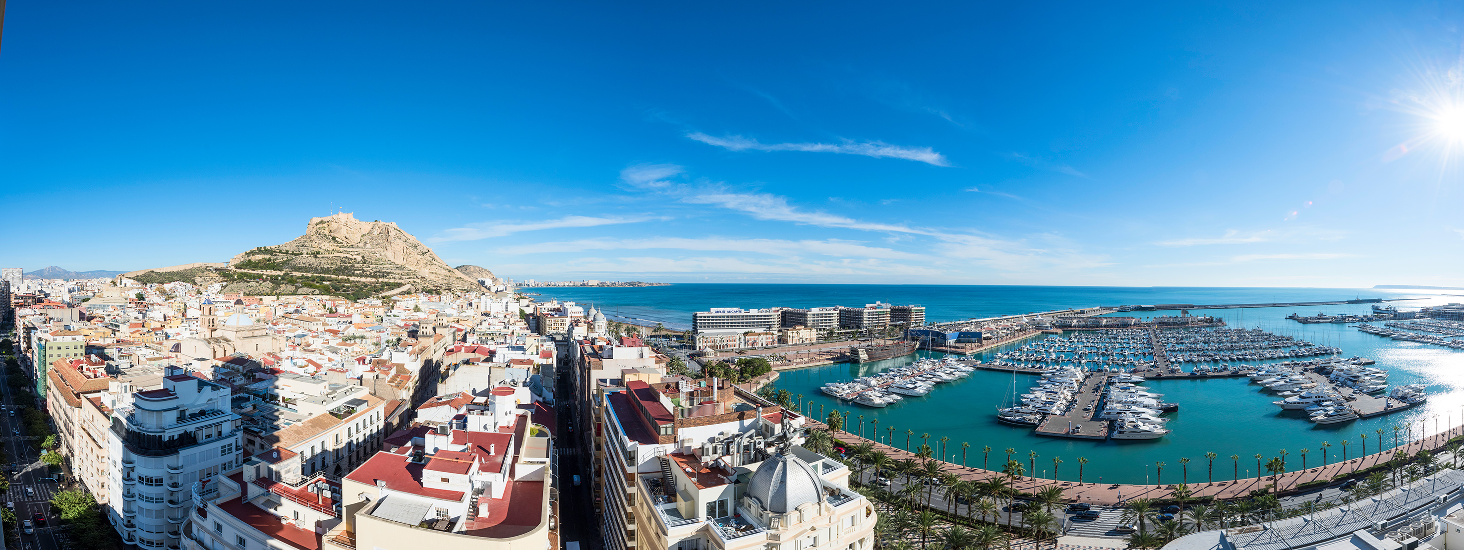 Alicante city panorama: Santa Bárbara Castle, coastline, and yacht marina.