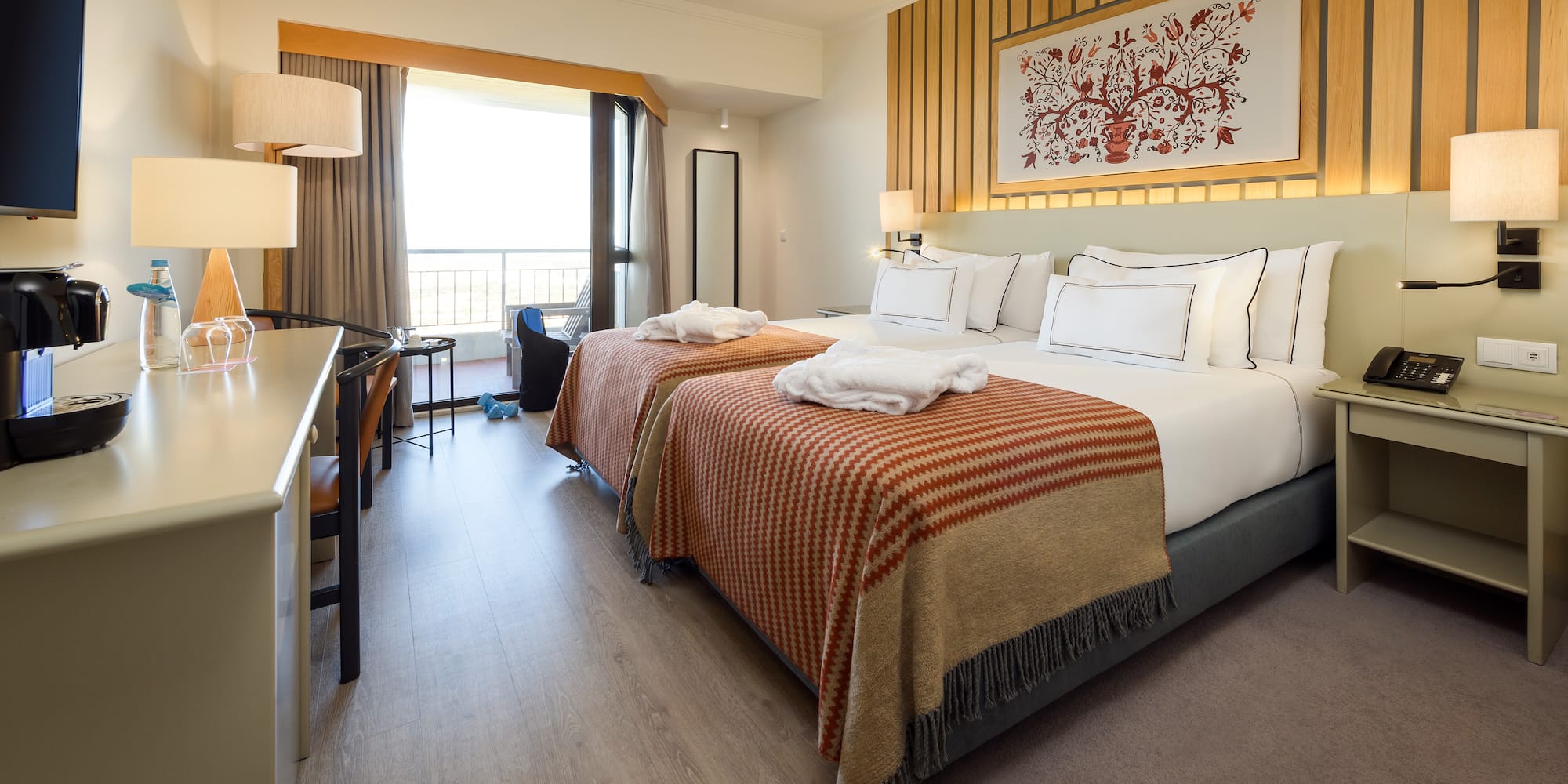 a room with two beds and a desk