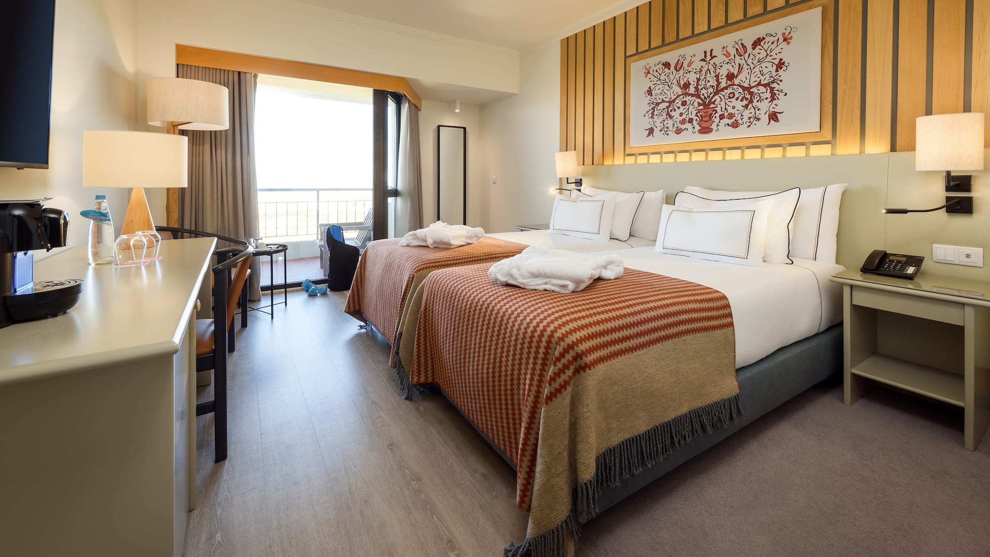 a room with two beds and a desk