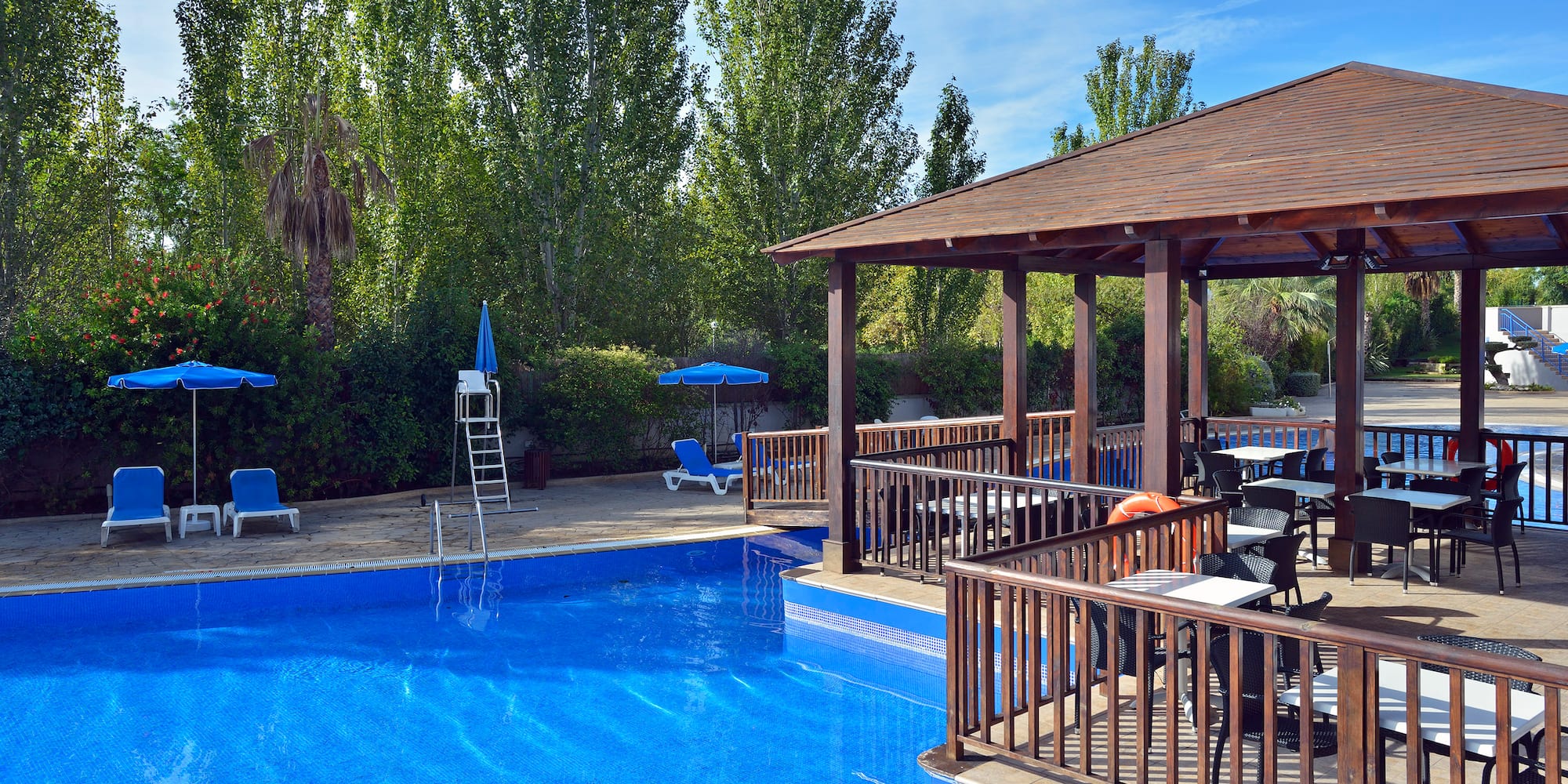 a pool with a deck and chairs
