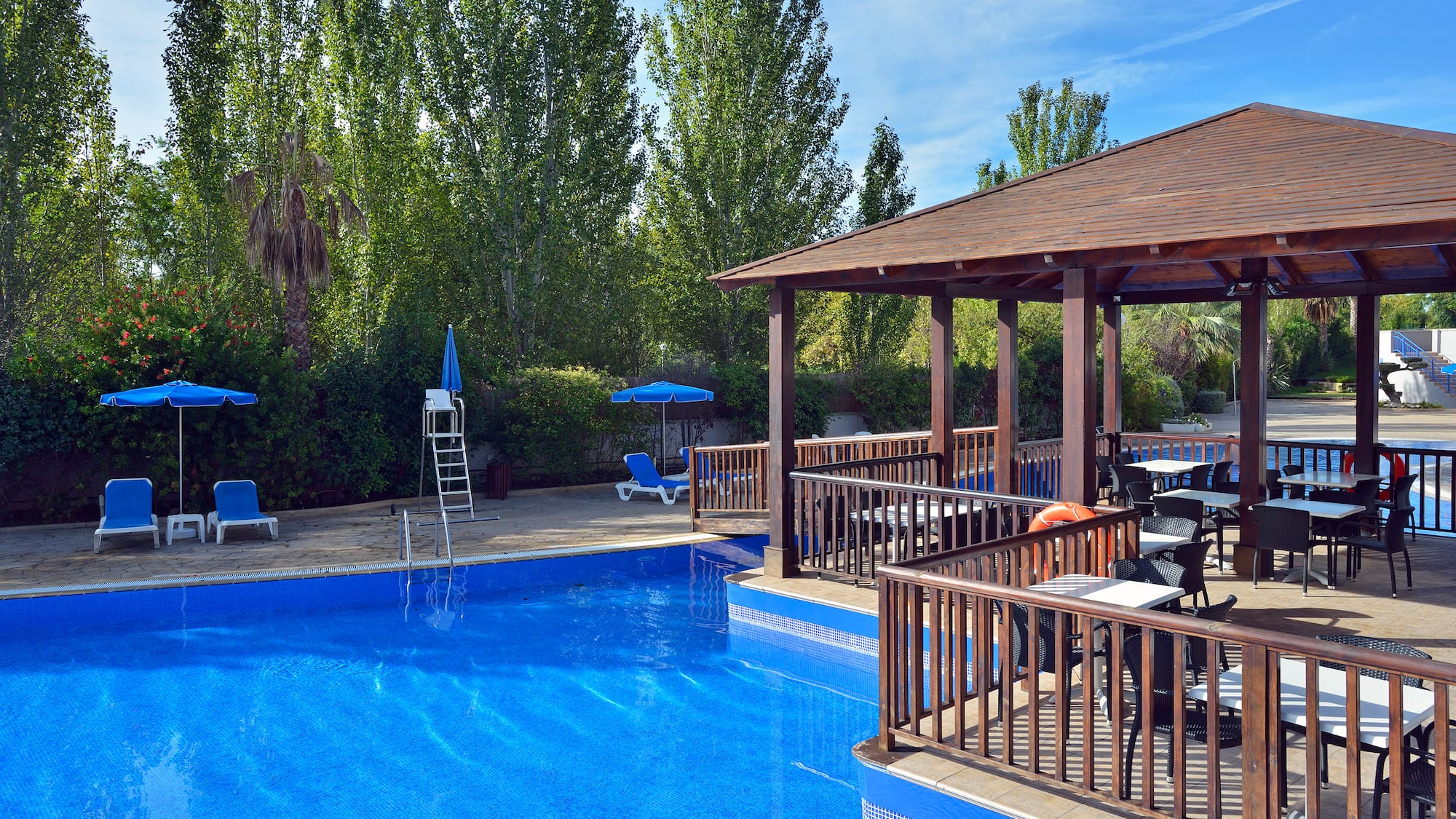 a pool with a deck and chairs