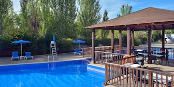 a pool with a deck and chairs