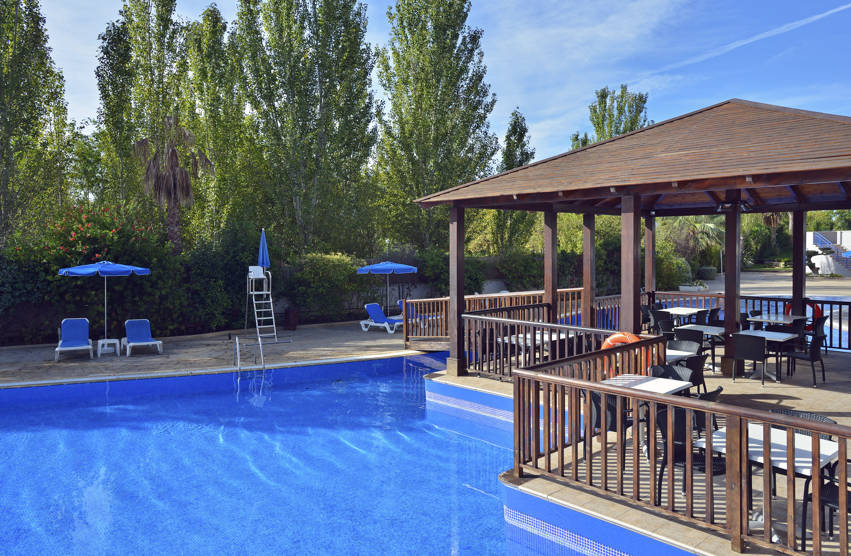 a pool with a deck and chairs