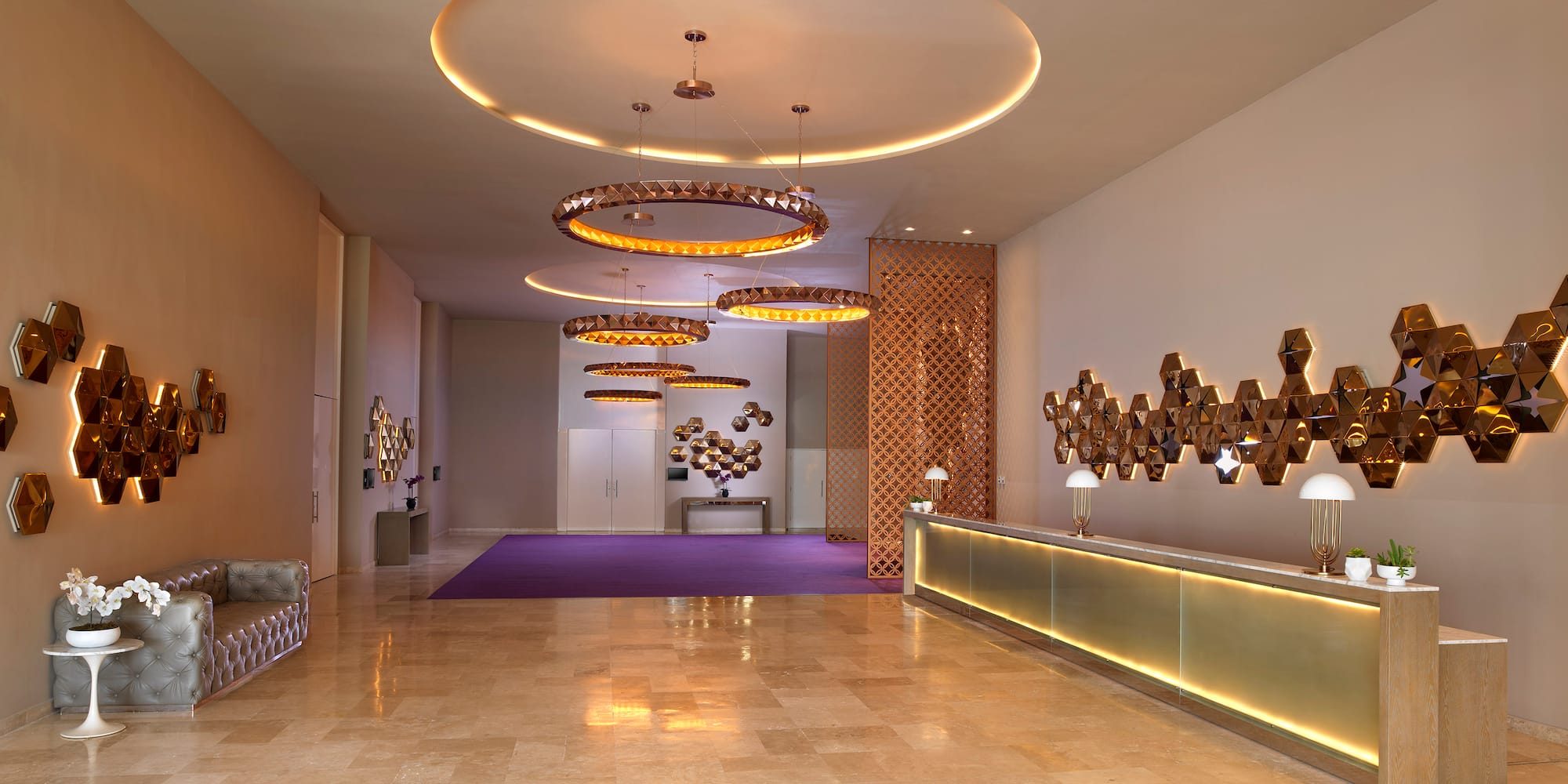 a lobby with a reception desk and lights
