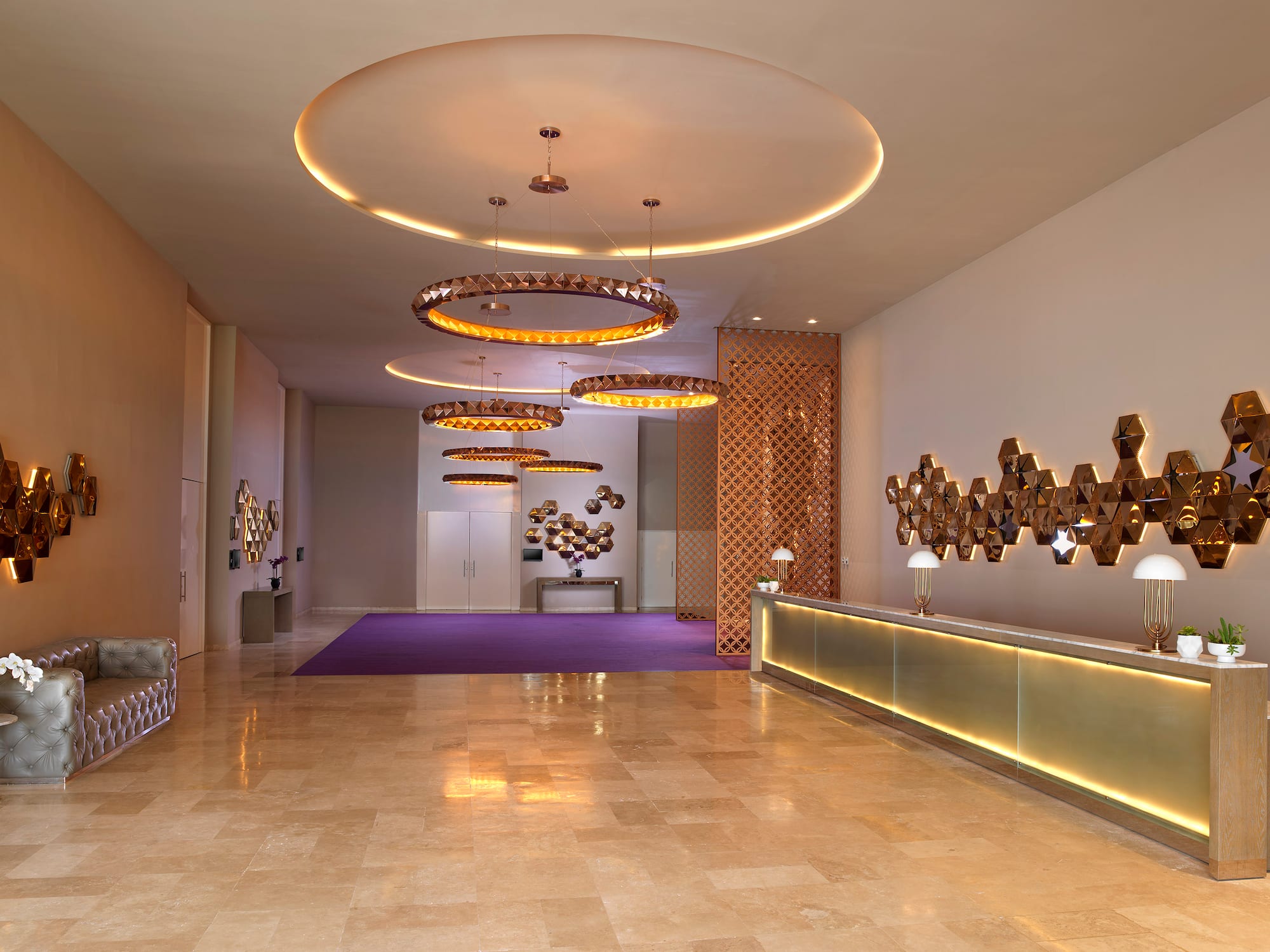 a lobby with a reception desk and lights