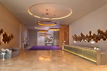 a lobby with a reception desk and lights