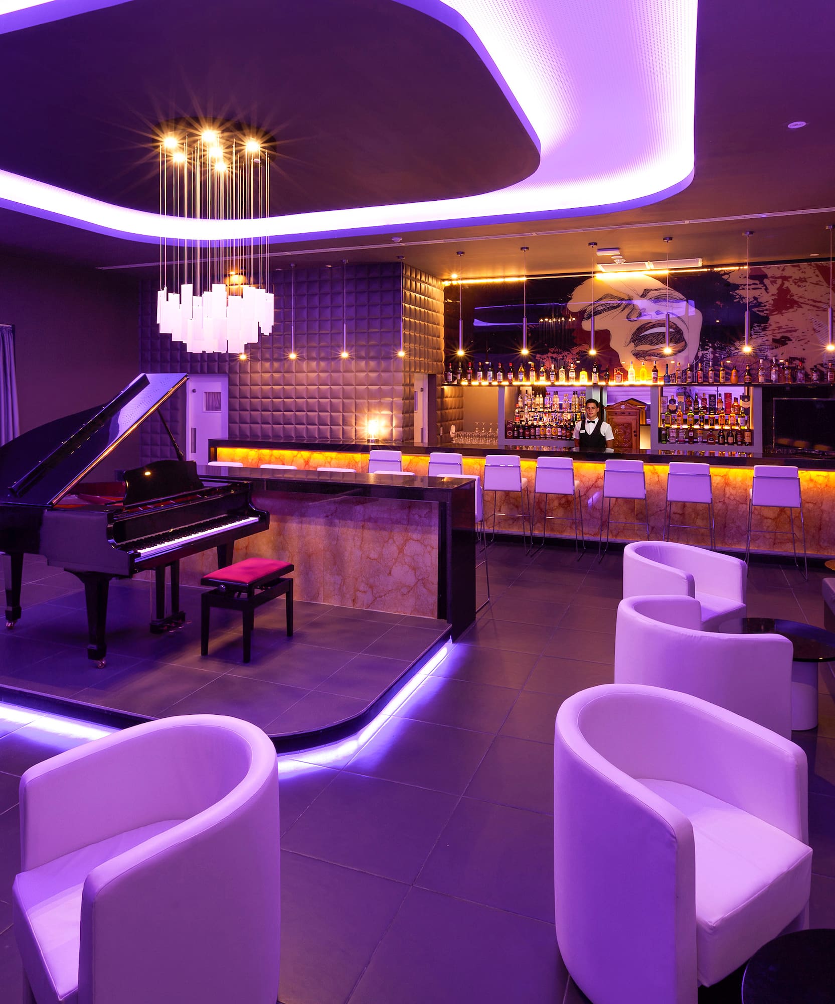 a room with a piano and chairs