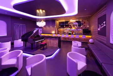 a room with a piano and chairs