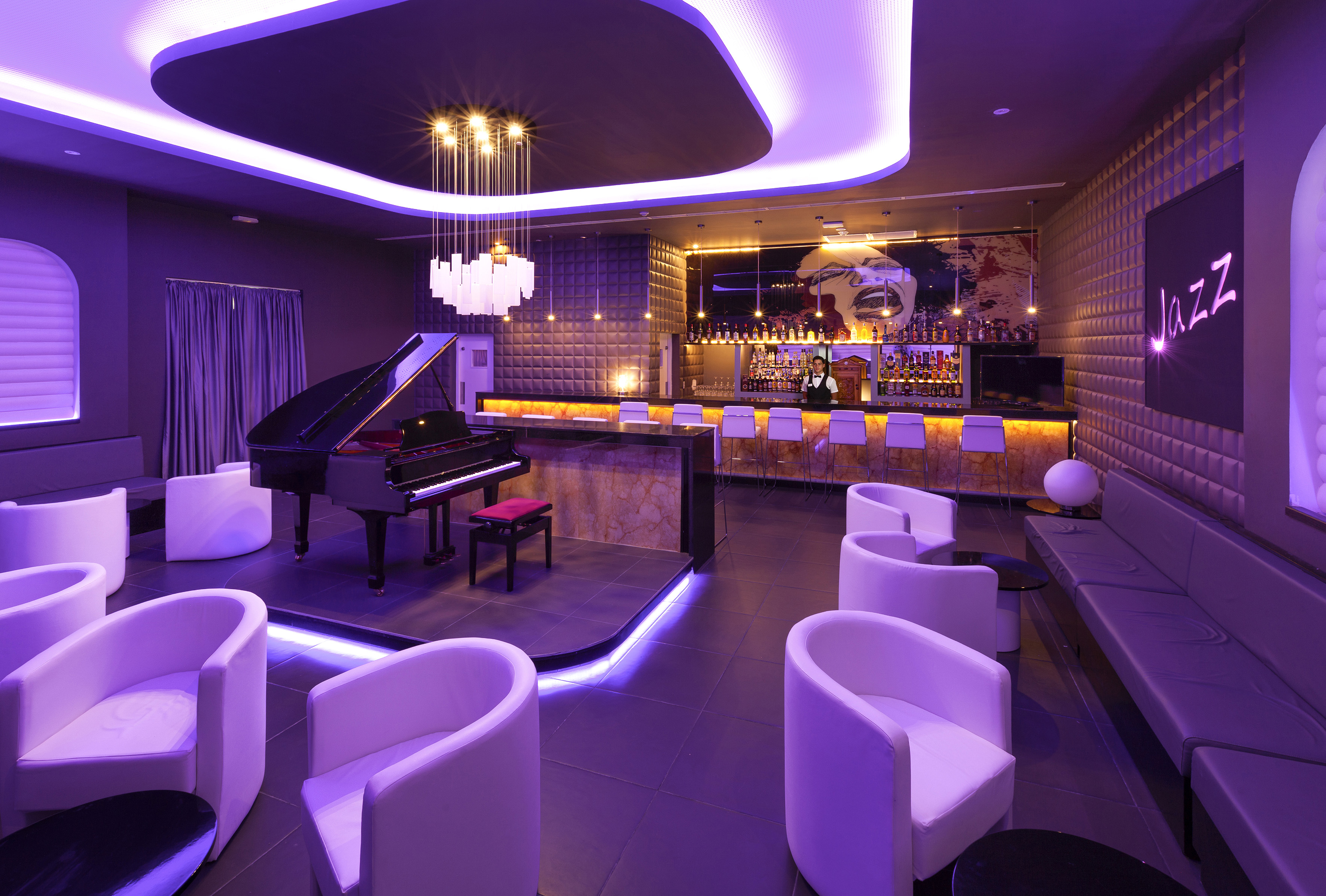 a room with a piano and chairs