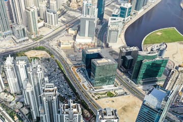 a city with many tall buildings and a river