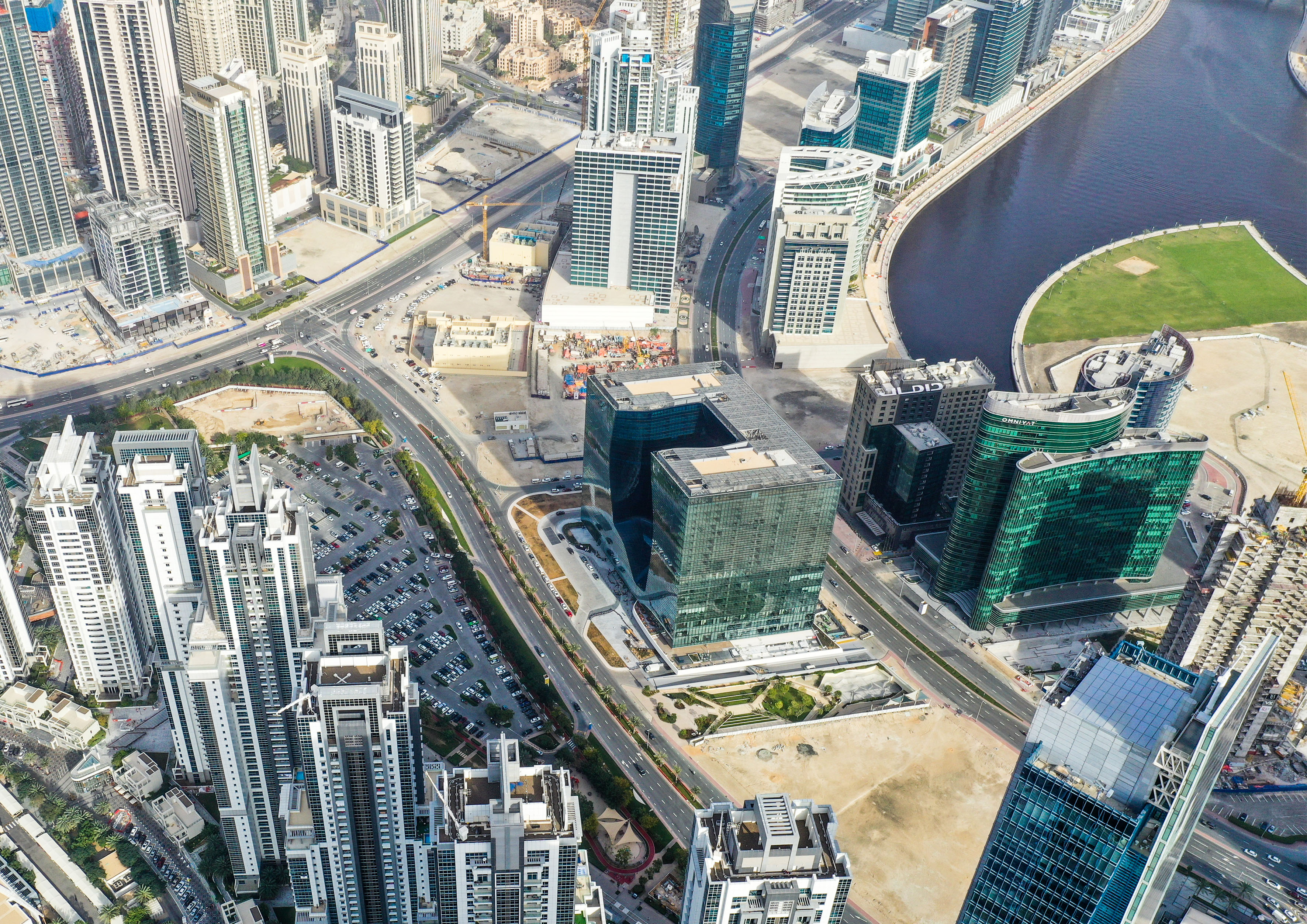 a city with many tall buildings and a river