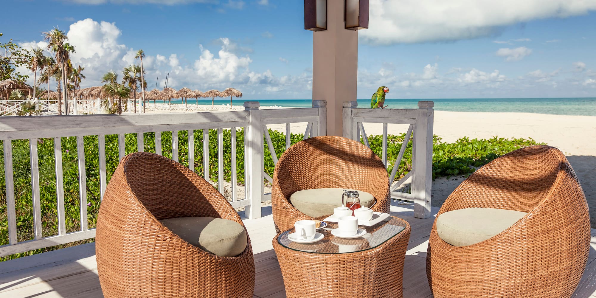 a wicker chairs and a table on a deck