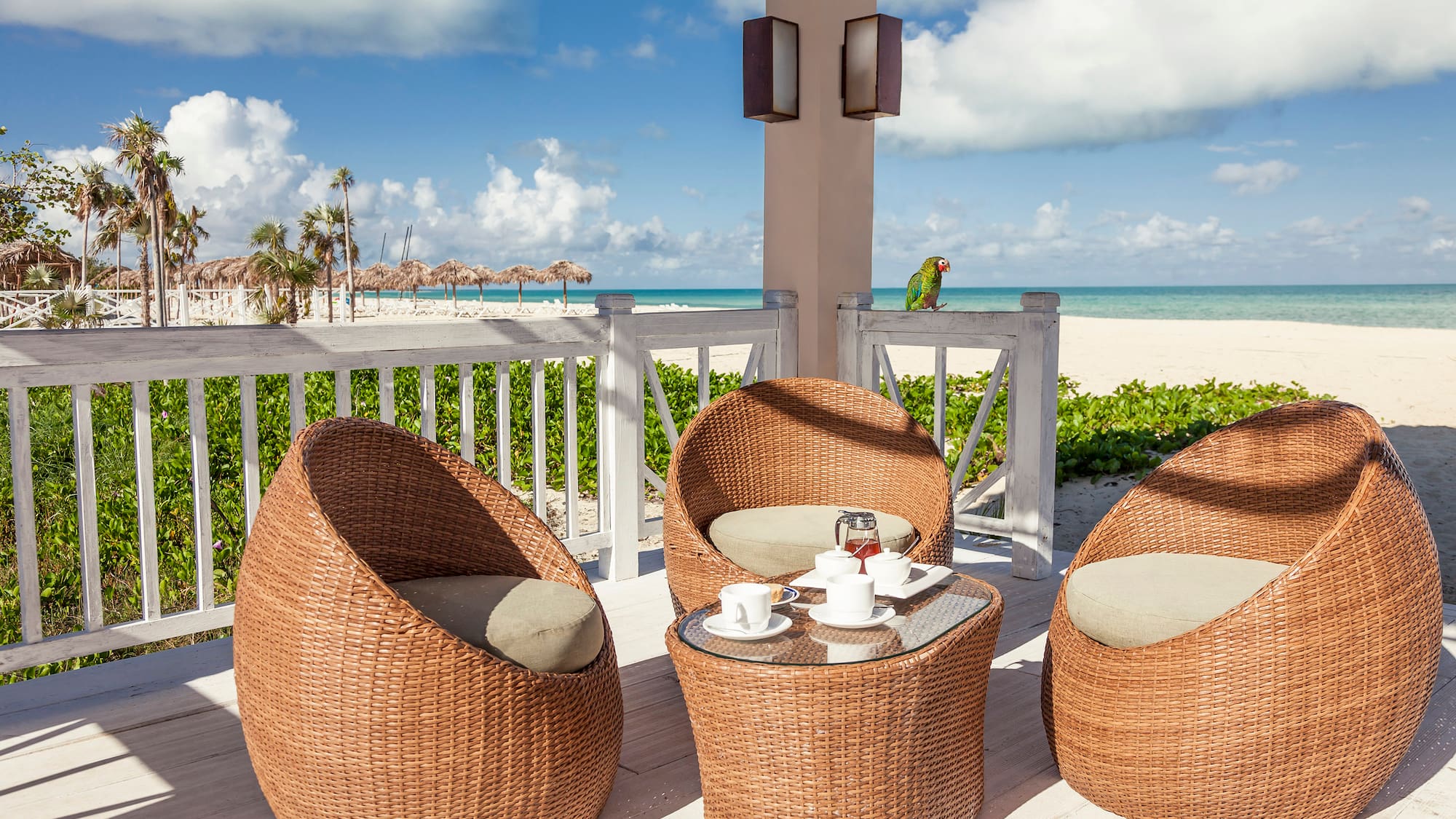 a wicker chairs and a table on a deck