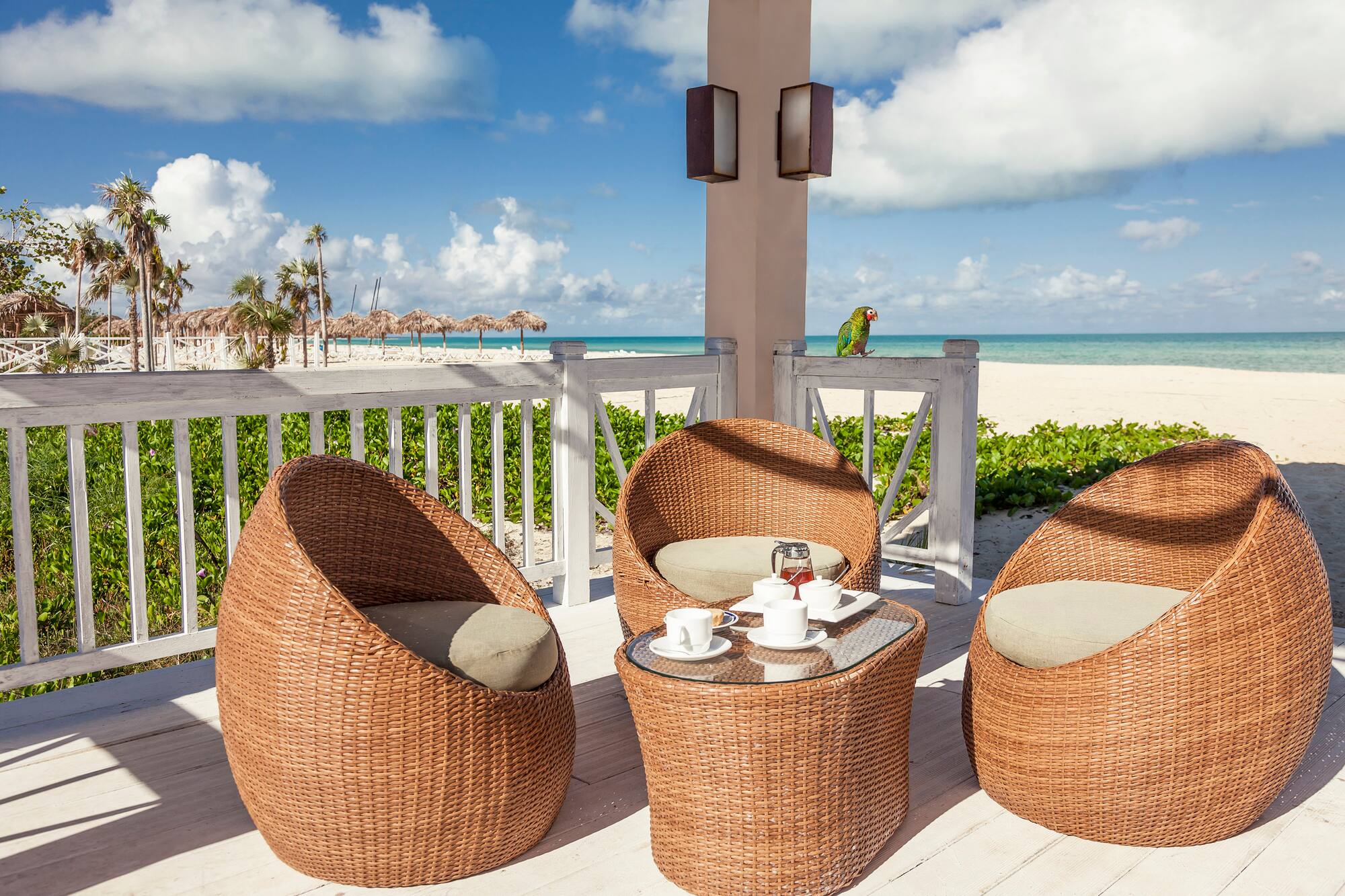 a wicker chairs and a table on a deck