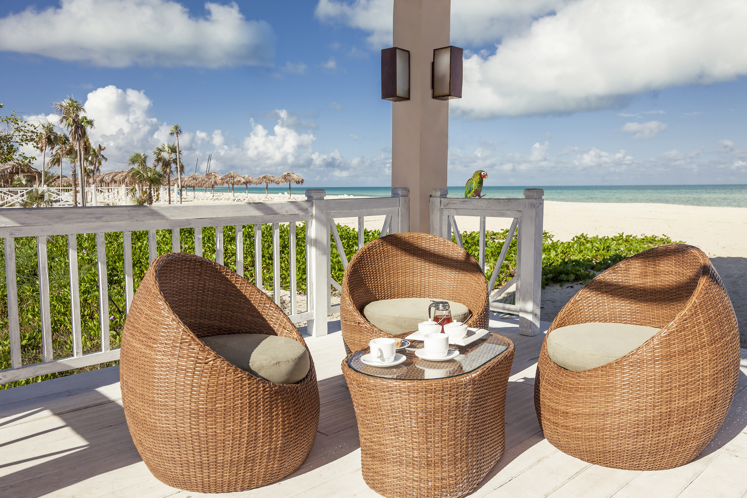 a wicker chairs and a table on a deck