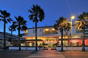 a building with palm trees and a street light