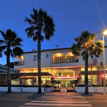 a building with palm trees and a street light