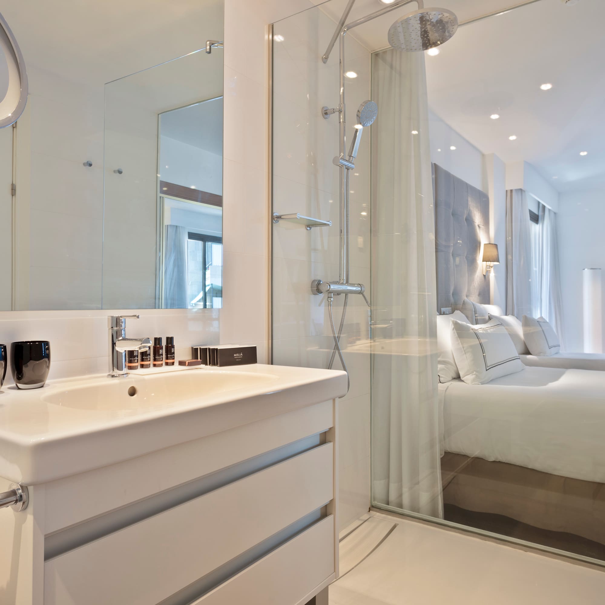 a bathroom with a shower and a bed